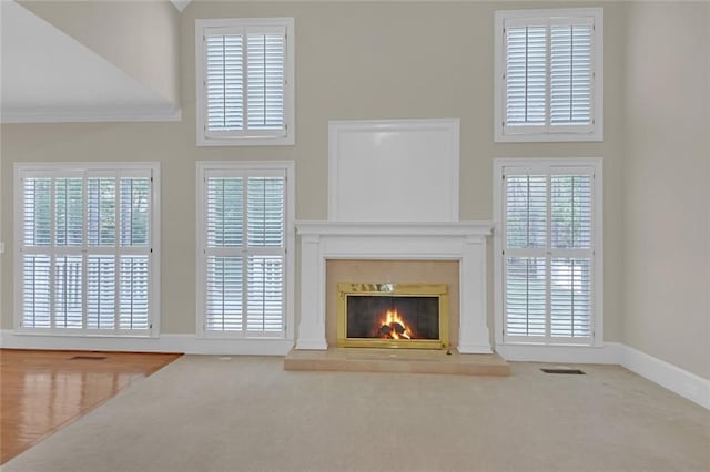 1405 Wilmington Way, Grayson, GA 30017 - unfurnished living room with carpet flooring, a glass covered fireplace, baseboards, and a high ceiling