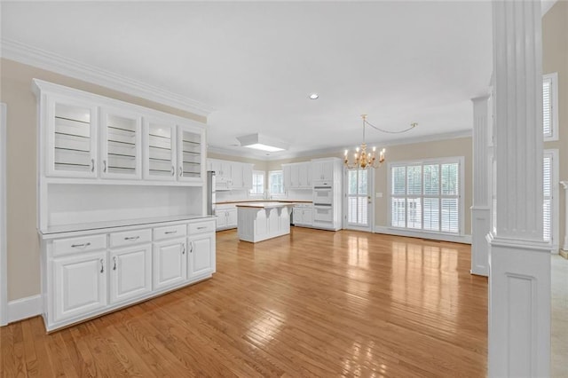 1405 Wilmington Way, Grayson, GA 30017 - unfurnished living room featuring a chandelier, light wood-type flooring, plenty of natural light, ornamental molding, and recessed lighting