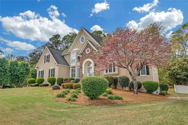 1405 Wilmington Way, Grayson, GA 30017 - view of front of house featuring a front yard, stucco siding, and stone siding