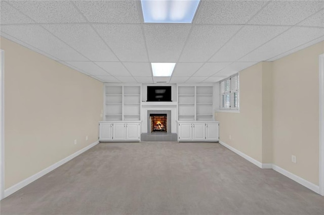 1405 Wilmington Way, Grayson, GA 30017 - unfurnished living room featuring built in shelves, baseboards, a tiled fireplace, and light colored carpet