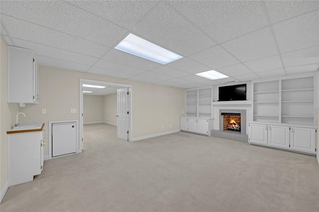 1405 Wilmington Way, Grayson, GA 30017 - unfurnished living room with baseboards, built in features, light carpet, a tiled fireplace, and a sink