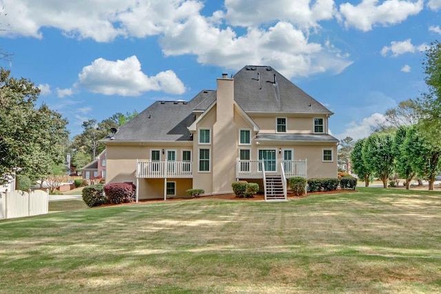 1405 Wilmington Way, Grayson, GA 30017 - rear view of house featuring stucco siding, a lawn, a chimney, and stairs