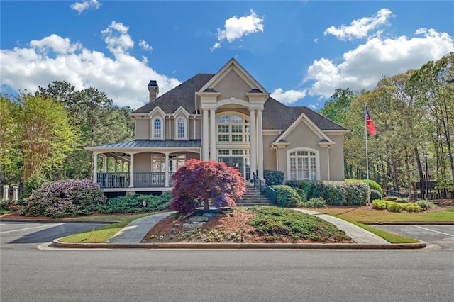 1405 Wilmington Way, Grayson, GA 30017 - view of front of home with a chimney, stucco siding, and uncovered parking
