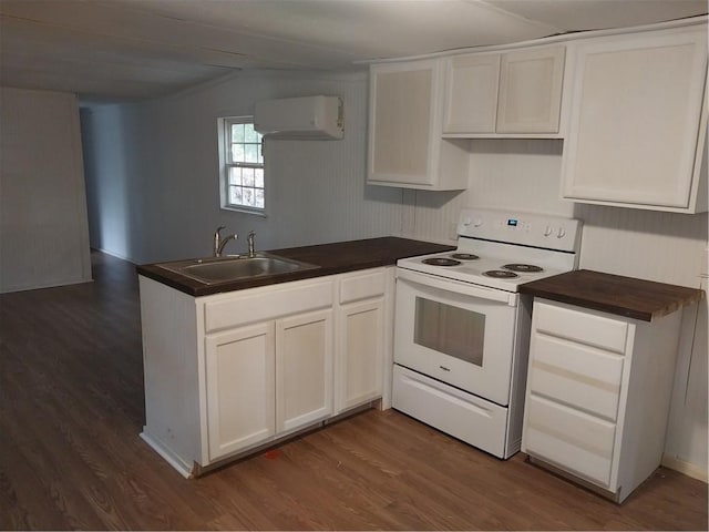 kitchen featuring white range with electric cooktop, a sink, a peninsula, white cabinets, and dark wood-style flooring