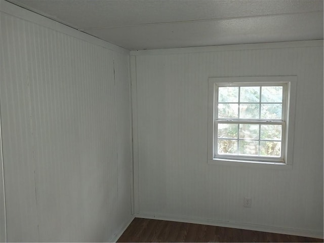 empty room featuring dark wood finished floors