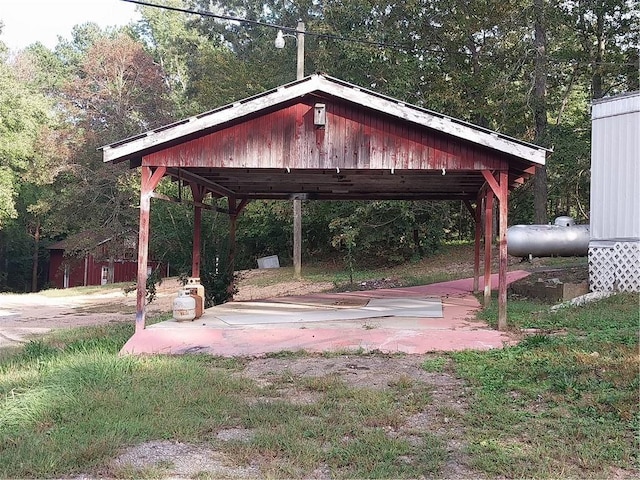 exterior space featuring a forest view and a carport