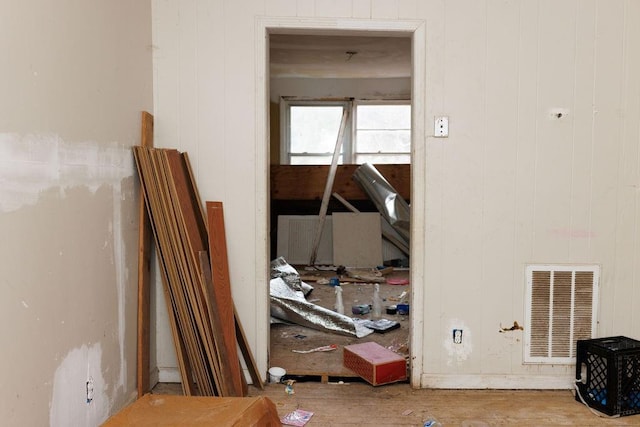 miscellaneous room with wood walls and wood-type flooring