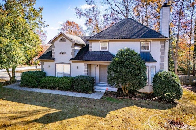 view of property featuring a front lawn