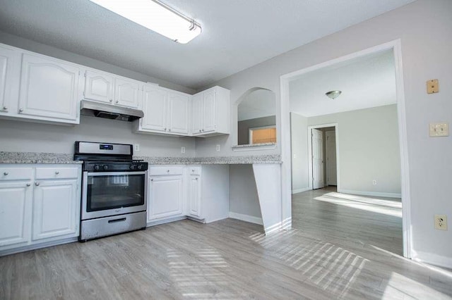 kitchen featuring light hardwood / wood-style flooring, stainless steel range with gas cooktop, and white cabinets