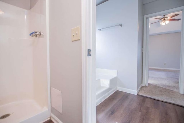 bathroom featuring hardwood / wood-style flooring, ceiling fan, and walk in shower