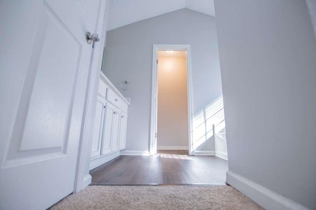 stairway with lofted ceiling and carpet flooring