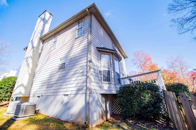 view of side of home with central air condition unit