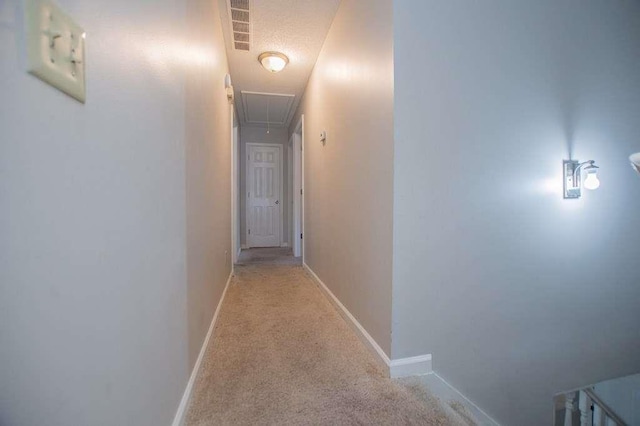 hallway featuring light carpet