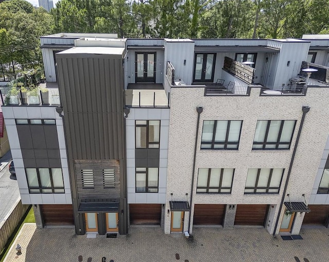 133 City View Ct NE, Atlanta, GA 30308 - view of building exterior featuring an attached garage and view of scattered trees
