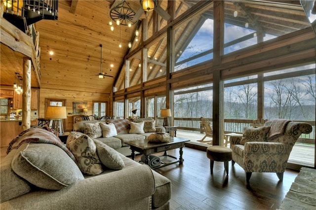 living room with ceiling fan, plenty of natural light, high vaulted ceiling, and hardwood / wood-style floors