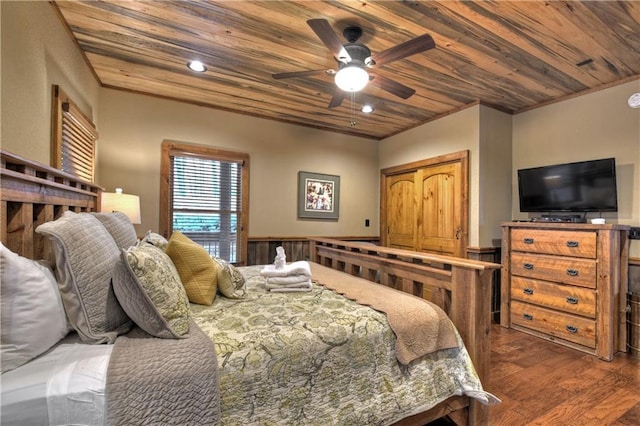 bedroom featuring ceiling fan, dark hardwood / wood-style floors, wood ceiling, and crown molding