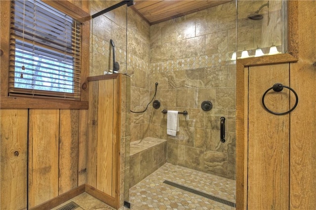 bathroom with an enclosed shower and wood walls