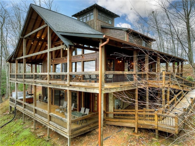 rear view of property featuring a deck