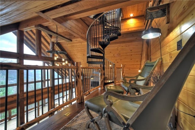 living area featuring vaulted ceiling with beams, wood walls, hardwood / wood-style floors, and wood ceiling