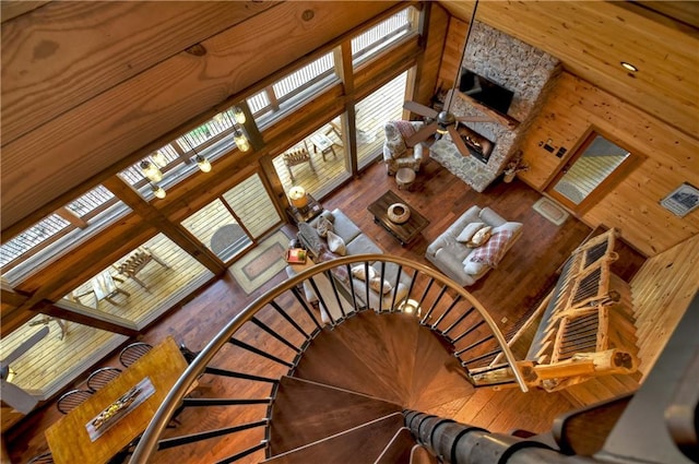 stairway with hardwood / wood-style floors and a high ceiling