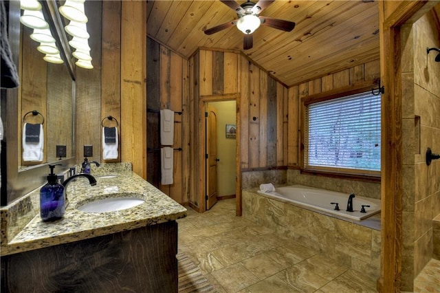 bathroom featuring vanity, vaulted ceiling, a relaxing tiled tub, ceiling fan, and wood ceiling