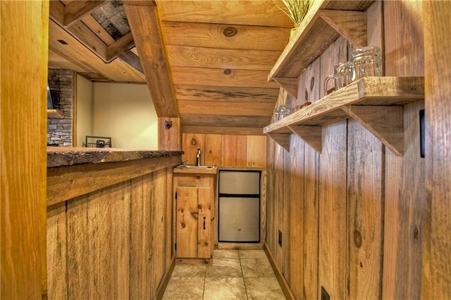 interior space featuring sink, wood walls, and wood ceiling