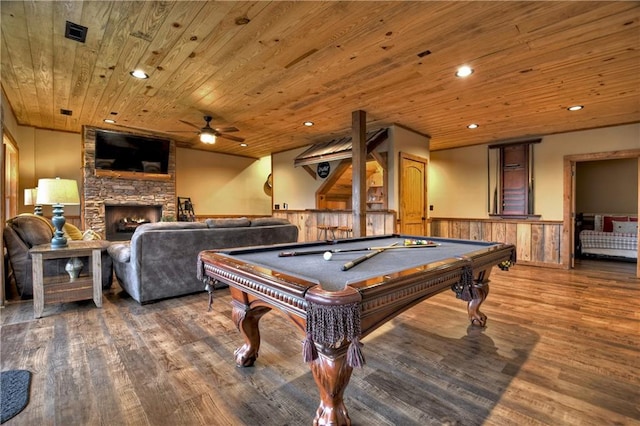 recreation room featuring wooden ceiling, billiards, hardwood / wood-style floors, a stone fireplace, and wood walls