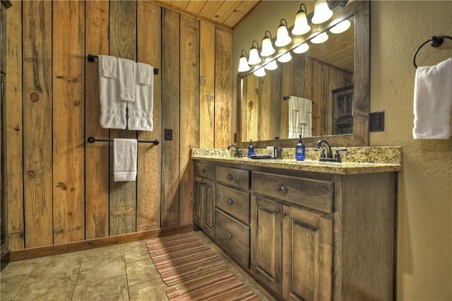 bathroom with vanity, wood walls, and wood ceiling