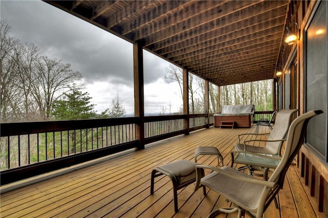 wooden deck featuring a hot tub