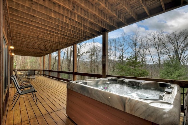 wooden deck featuring a hot tub