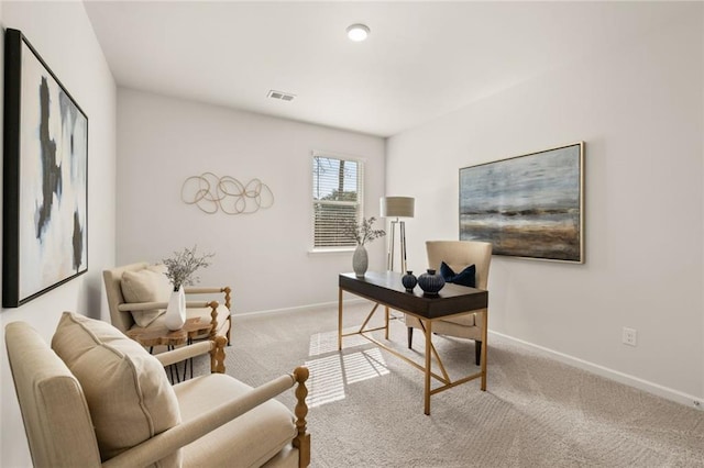 carpeted office featuring visible vents and baseboards