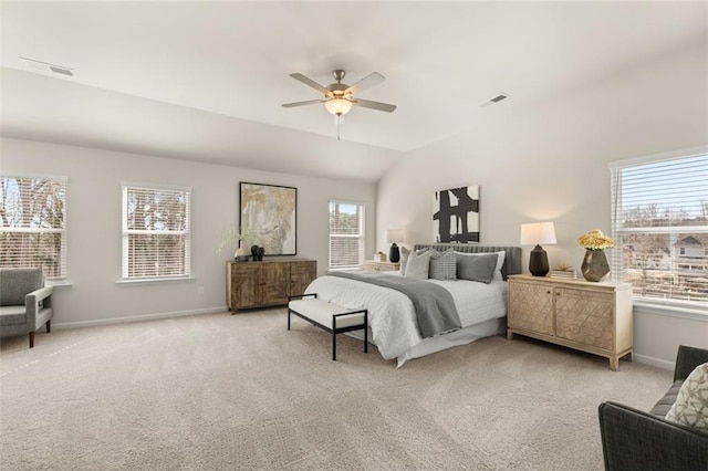 bedroom featuring baseboards, light carpet, and multiple windows