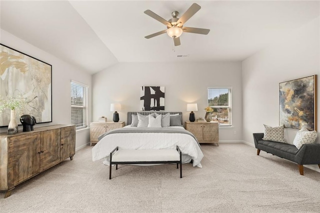 bedroom with lofted ceiling, a ceiling fan, light colored carpet, and baseboards