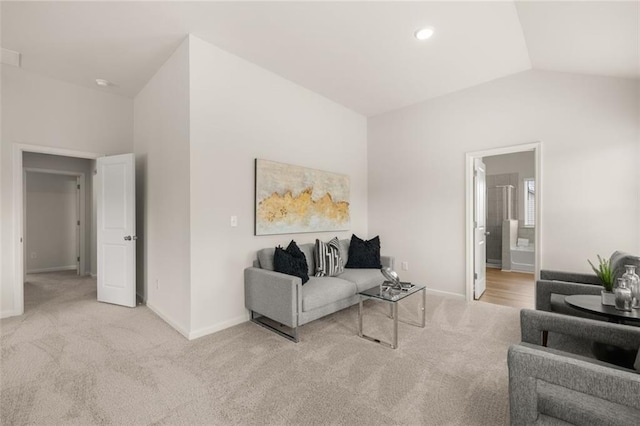 carpeted living room with baseboards, recessed lighting, and lofted ceiling