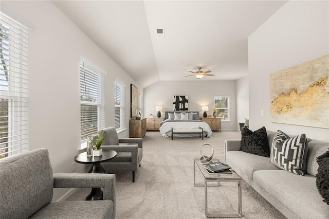 carpeted bedroom with multiple windows, ceiling fan, lofted ceiling, and visible vents