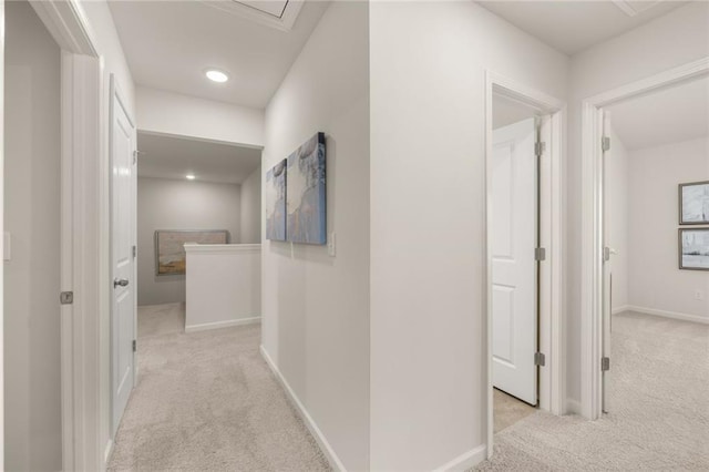 hallway featuring baseboards, recessed lighting, and carpet