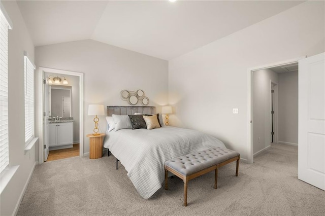 bedroom with lofted ceiling, light colored carpet, baseboards, and multiple windows