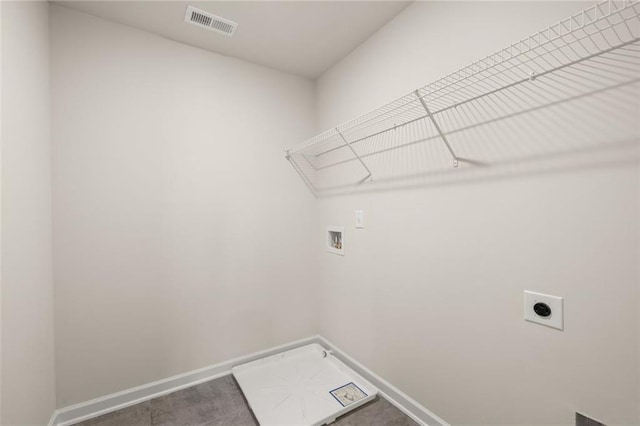 laundry room featuring laundry area, electric dryer hookup, washer hookup, baseboards, and visible vents