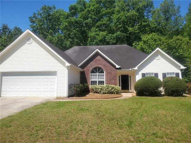 single story home featuring a front lawn, an attached garage, driveway, and brick siding