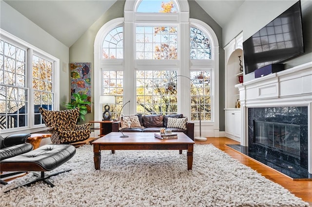 sunroom / solarium with a fireplace and a healthy amount of sunlight