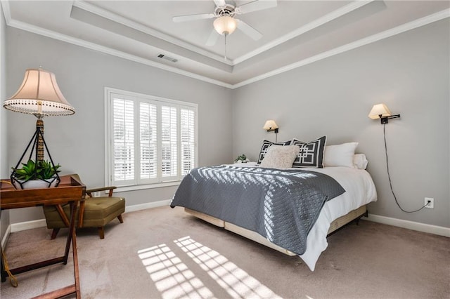 carpeted bedroom featuring a raised ceiling, ceiling fan, and ornamental molding