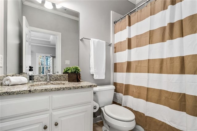 bathroom with walk in shower, toilet, vanity, and ornamental molding