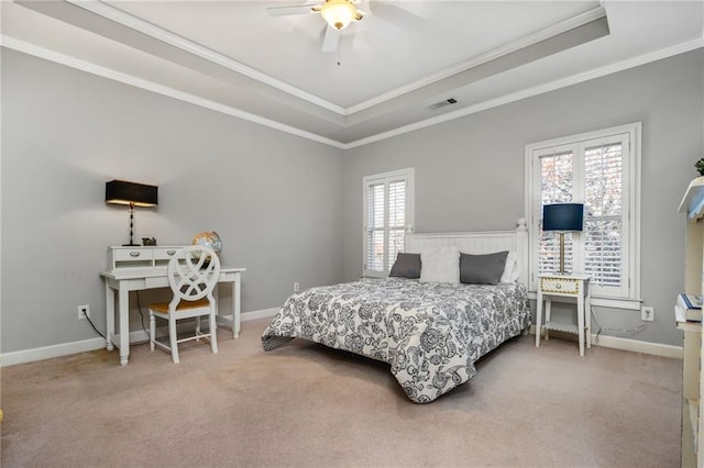 carpeted bedroom featuring a raised ceiling, multiple windows, and ceiling fan