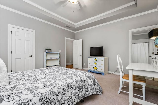 carpeted bedroom featuring ceiling fan, a raised ceiling, and ornamental molding