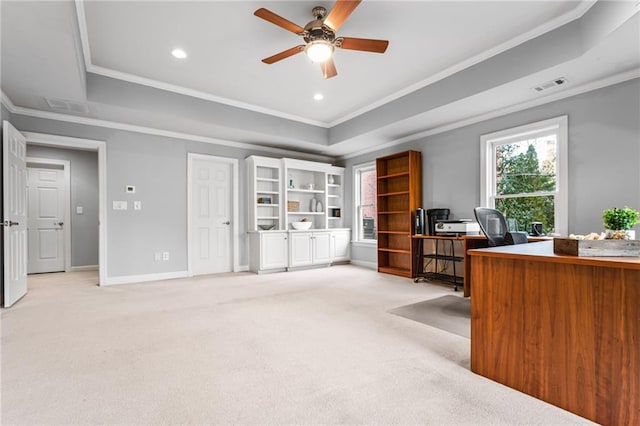 carpeted office featuring ceiling fan, a raised ceiling, and crown molding