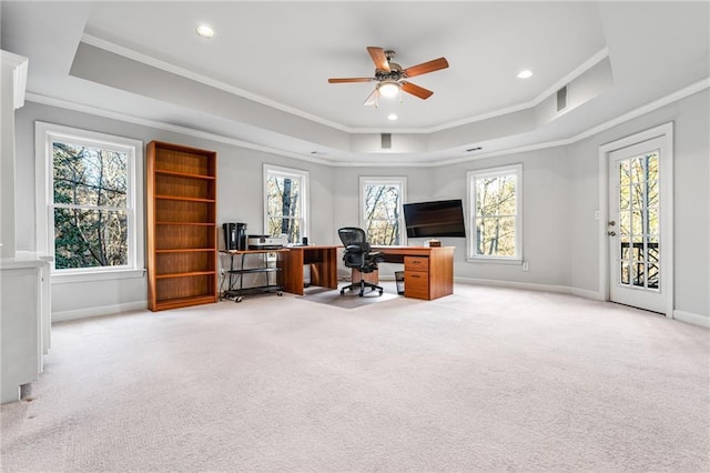 carpeted office with a raised ceiling, ceiling fan, and ornamental molding