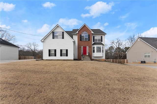 front of property with cooling unit and a front lawn