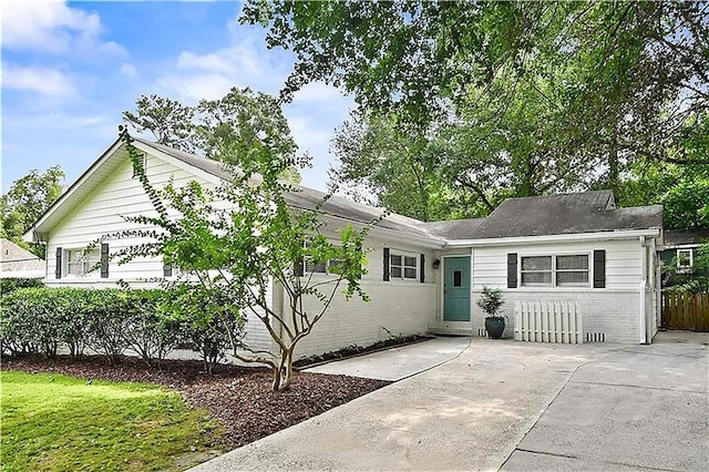 ranch-style house with brick siding and fence