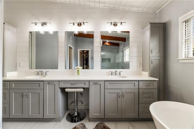 bathroom with a wealth of natural light, double vanity, and a sink