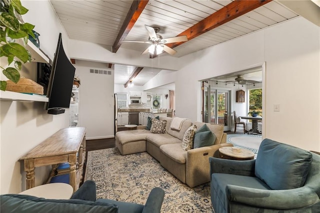 living area with wood finished floors, beamed ceiling, a ceiling fan, and visible vents